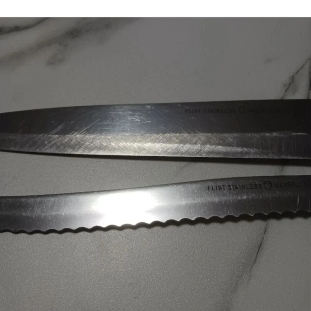 Pair of stainless steel Knives by Flint made in USA Surface scratches Partial